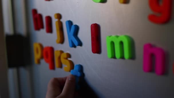 Toddler Playing Colorful Fridge Magnets — Stock Video