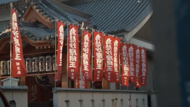 Banderas Rojas Con Inscripciones Ondeando Contra Templo Japonés — Vídeos de Stock