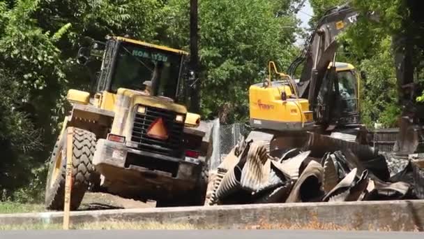 Carregador Frontal Afasta Uma Pilha Metal Torcida Enquanto Uma Escavadeira — Vídeo de Stock