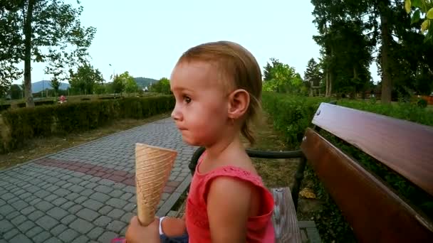 Küçük Kız Parkta Bir Bankta Oturuyor Dondurma Yiyor — Stok video