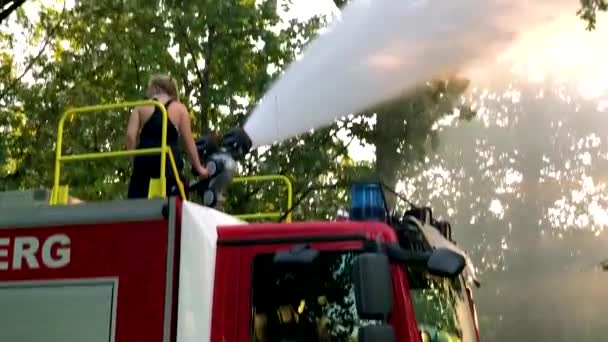 Camión Bomberos Alemán Rociando Agua Para Niños Árboles Día Caluroso — Vídeos de Stock