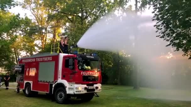 Duitse Brandweerwagen Sproeit Water Voor Kinderen Bomen Een Warme Zomerdag — Stockvideo