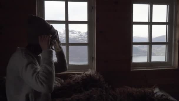 Woman Sitting Grey Sweater Covered Sheep Fur Wooden Cabin Putting — Stock Video