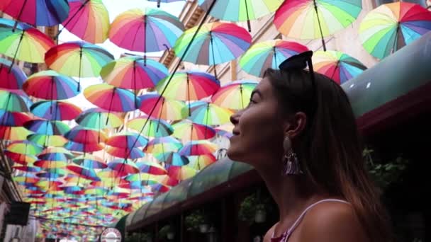 女孩抬头看彩色雨伞时的慢动作 — 图库视频影像
