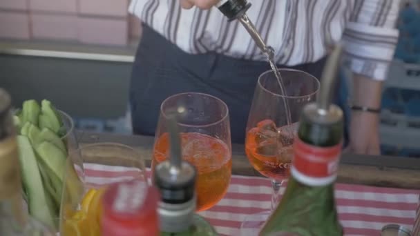 Barkeeper mixing a drink called Aperol spritz. (adding Prosecco) //close up, hand held, High Angle, slow motion (made with 50fps)//