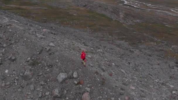 東グリーンランドの山岳氷河を走るトレイルランナーの空中展望 — ストック動画