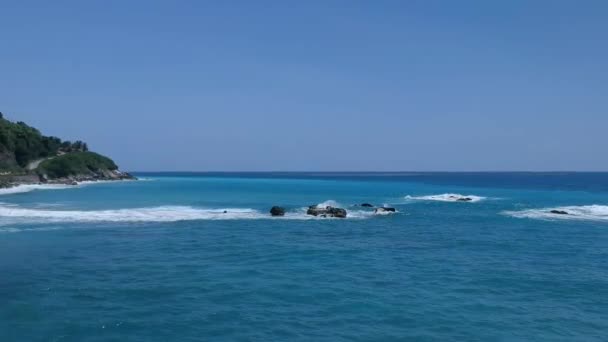 파도가 바위들을 무너뜨리면서 청록색 카리브해 의물이 보이는 각도의 목적지 경치를 — 비디오