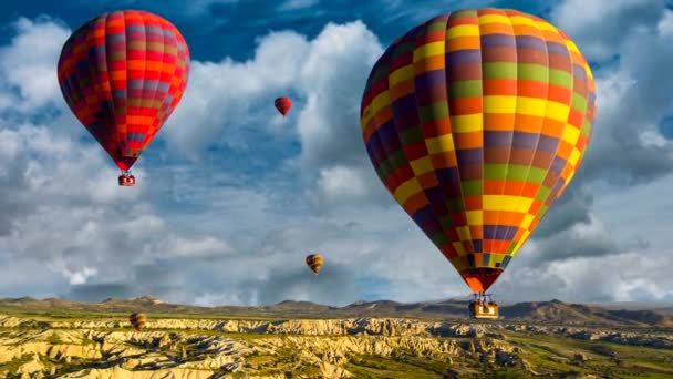 Cinemagraph with parallax effect of hot air balloons rising over the Cappadocia, Turkey desert within the chidring time lapse clouds.
