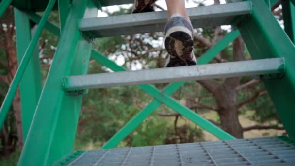Unrecognizable Young Woman Climbing Green Metal Stairs Slow Motion — Stock Video