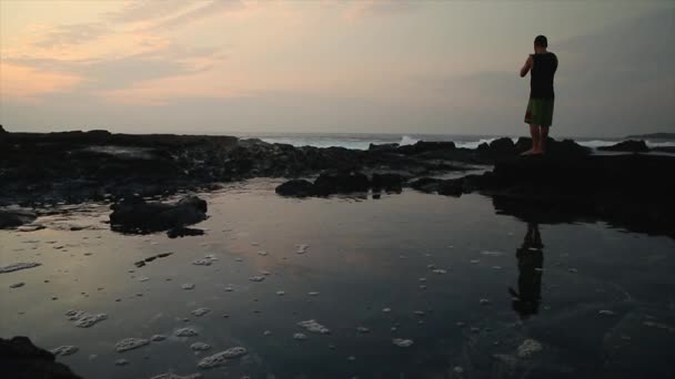 Man Taking Photo Crashing Waves Sunset — Stock Video