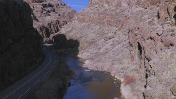 Dramatic Aerial Drone Shot High Desert Canyon River Road Bottom — Vídeos de Stock