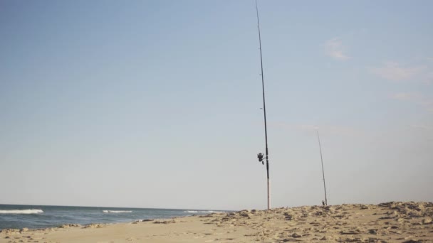 Tall Fishing Rods Lined Coastline Beach Fishing Vacation Waves — Stockvideo