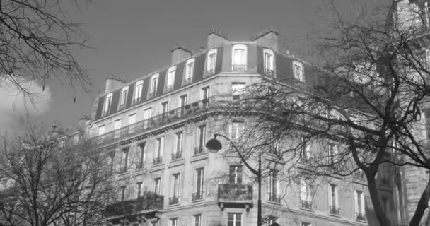 Black And White Exterior Facade Of A Typical Haussmannian Building In Paris, France. low angle