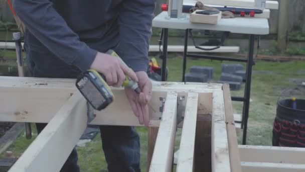 Carpenter Using Electric Drill Screw Nails Wooden Frame Patio Deck — Video Stock