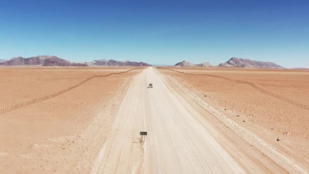 Drone Shot Vehicle Driving Dusty Trail Desert Namibia Wide Aerial — Stock videók