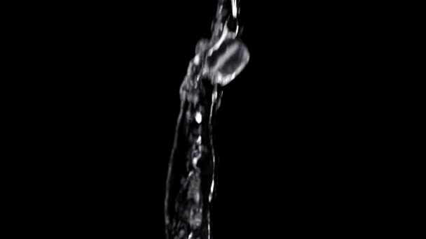 extreme slow motion of fresh clean water with ice cube throw in the air with isolated black background