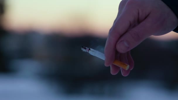 Close Male Caucasian Hand Holding Lit Cigarette Outdoors — Vídeo de stock