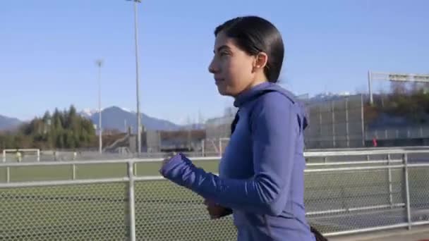 Determined Young Woman Jogging Track Field Path Closeup Follow Shot — Vídeos de Stock