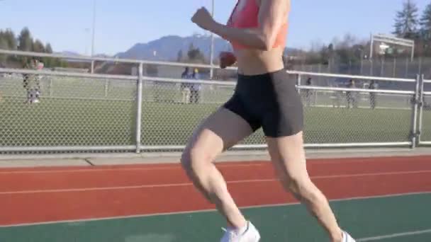 Young Latina Woman Runs Track Orange Sports Bra Tilt Follow — Stockvideo