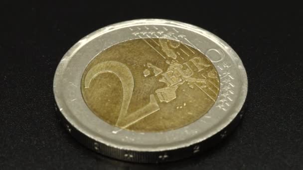 One Shiny Two Euro Coin Rotating Black Surface Background Extreme — Stockvideo