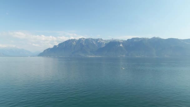 Aerial Lake Geneva Mountains Background Small Boat Foreground — стокове відео