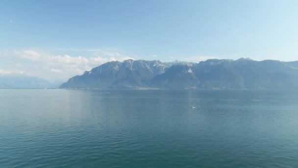 Aerial Lake Geneva Mountains Background Small Boat Foreground — Stock video