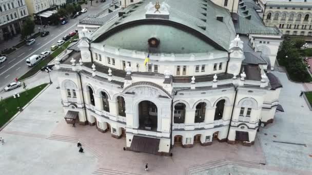 4K Aerial Drone Footage of National Opera of Ukraine opera house building with a close-up.Two nuns walking towards the building and a kid with a skate board on the right side of the building