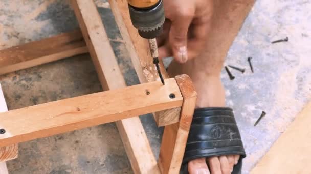 Skillfull Carpenter Employing Power Drill Attaching Screws Small Wooden Chair — Stockvideo
