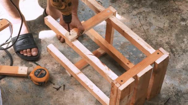 Skillfull Carpenter Employing Power Drill Attaching Screws Small Wooden Chair — Stockvideo