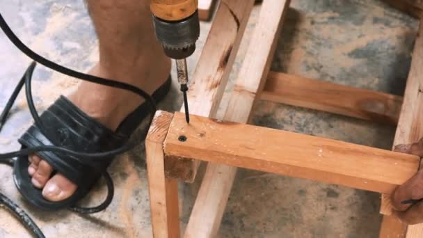 Skillfull Carpenter Employing Power Drill Attaching Screws Small Wooden Chair — Stockvideo