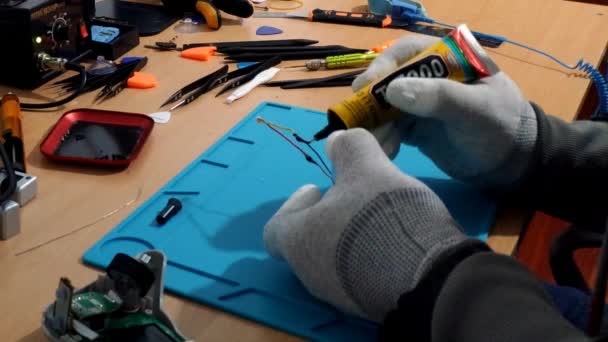 Gloved Hands Technician Applying Insulation Gel Battery Wires Indoors Workbench — Video Stock