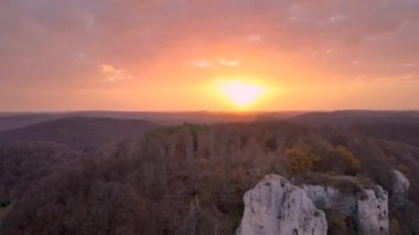 Aerial view of sunrise over panoramic rock and forest in Swabian Alb, Germany