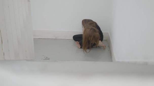 Young Woman Sits Corner Stairwell Moves Hair Face — Vídeo de stock