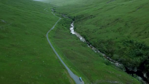 Pan Drone Shot Reveals Country Road Scottish Highlands — Vídeos de Stock