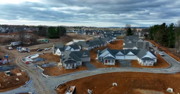 New home starts. Residential house construction underway. Aerial with unpaved street and driveway.