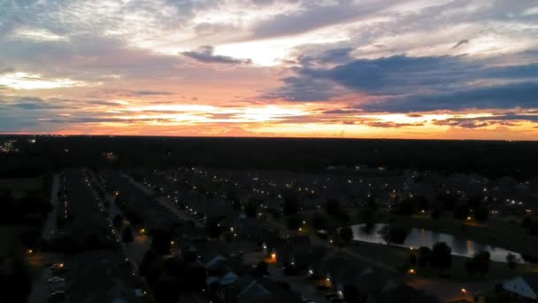 Ζωντανό Ηλιοβασίλεμα Πάνω Από Φώτα Του Δρόμου Γειτονιά Και Λίμνη — Αρχείο Βίντεο