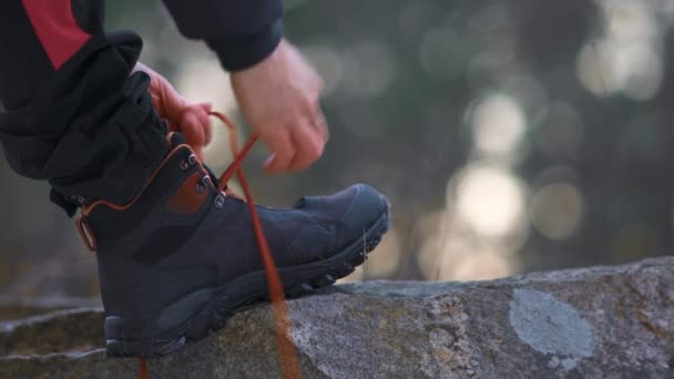 Man Stepping Rock Tying His Shoelaces Outdoors Hiking — Stock Video