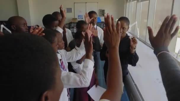 Young African Students Raise Hands Excitedly Touch Large Rough Diamond — Stock Video