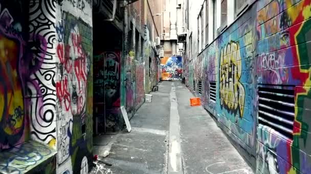 FPV of an empty alley with walls full of grafitis, unrecognizable urban art concept with graffiti