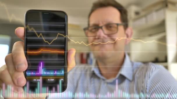 Happy Businessman Glasses Holding Smartphone Glowing Candlesticks Showing Stock Market — Video Stock