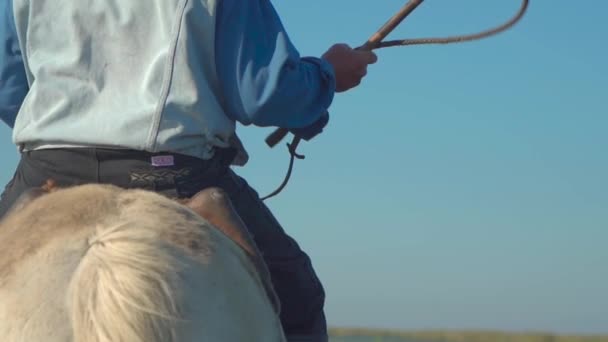 Rural Man Horseback Rides White Horse Swings Crop Slow Motion — Video