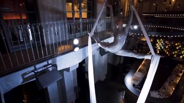 Female Aerialist Doing Front Split Turn White Silks Bar — Video