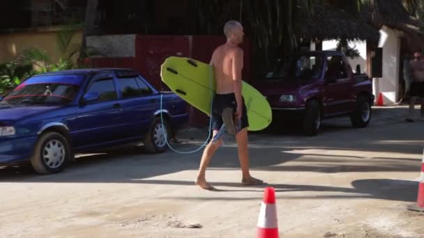 Caucasian Shirtless Male Surfer Green Surf Board Walking Barefoot Muddy — Stock Video