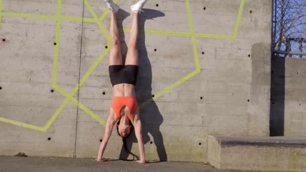 Woman Doing Handstand Concrete Wall Outdoors — Stockvideo