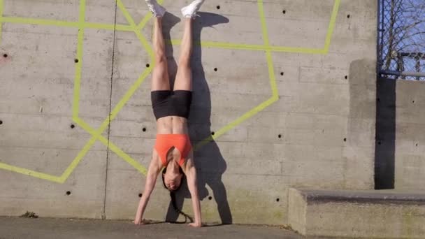 Woman Doing Handstand Concrete Wall Outdoors — Video Stock