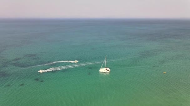 Aerial Shot Catamaran Turquoise Sea Other Boats Passing — стоковое видео