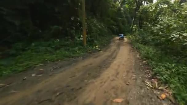 Fpv Drone Shot Road Vehicle Driving Puddle Deep Jungle — Stockvideo