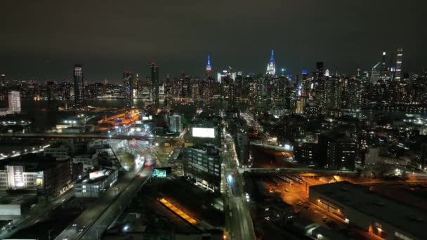 ニューヨークのロングアイランドシティ上空からの夜景 クイーンズからマンハッタンの東側に向かってゆっくりとドルリードローンカメラ — ストック動画