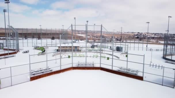 Tilt Baseball Softball Field Backstop Winter Snow Aerial — стоковое видео