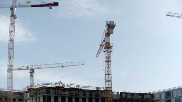 Tower Cranes Work Construction Site Daytime Low Angle — Vídeo de Stock